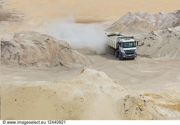 Truck driving through sand heaps