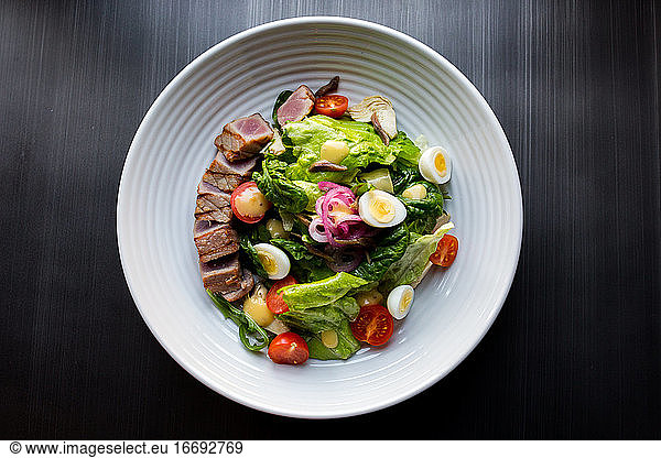 Tuna salad with tomato  egg  herbs and sauce