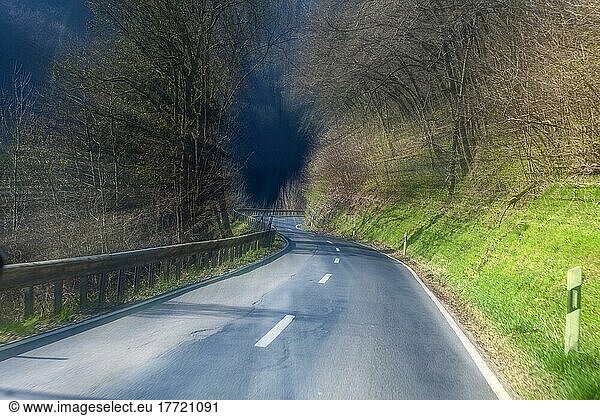 Tunnel vision of motorist speeding at excessive speed on dangerous winding country road  Germany  Europe