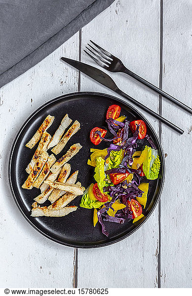 Turkey meat strips with vegetable salad