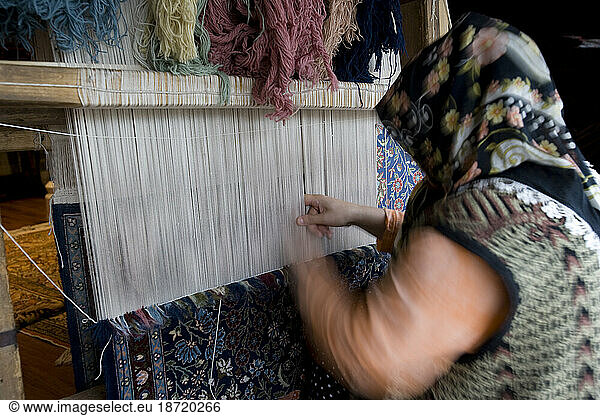 Turkish woman carpet weaving at the Elegance Rug Gallery  Sultanahmet