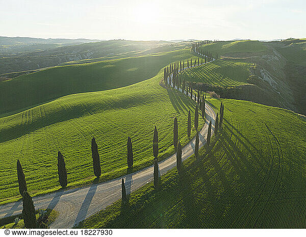 tuscany fields and roads from aerial view at sunrise