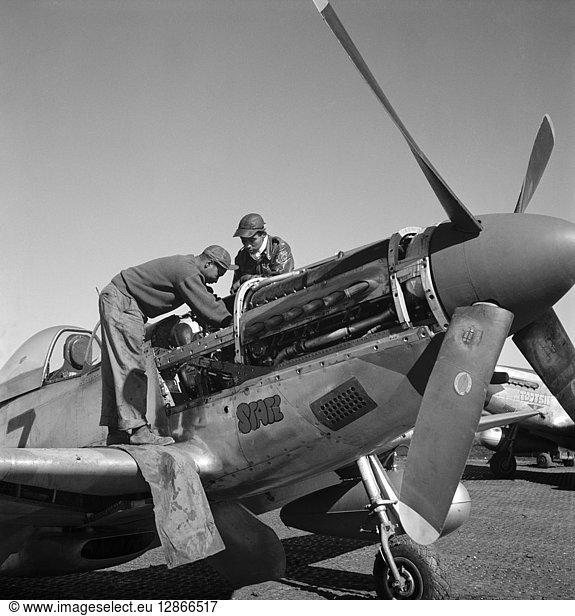 TUSKEGEE AIRMEN  1945. Tuskegee Airmen mechanics Marcellus Smith (left) and Roscoe Brown  working on a fighter plane at Ramitelli Airfield  Italy. Photograph by Toni Frissell  March 1945.