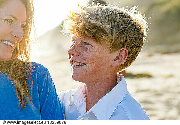 Tween Boy With Freckles Smiles Lovingly At Mother