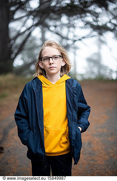 Tween boy with glasses outside on hike