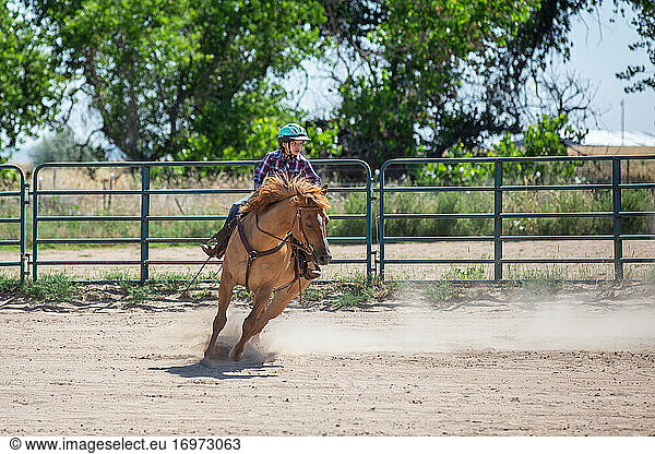 Tween girl running her horse in an arena