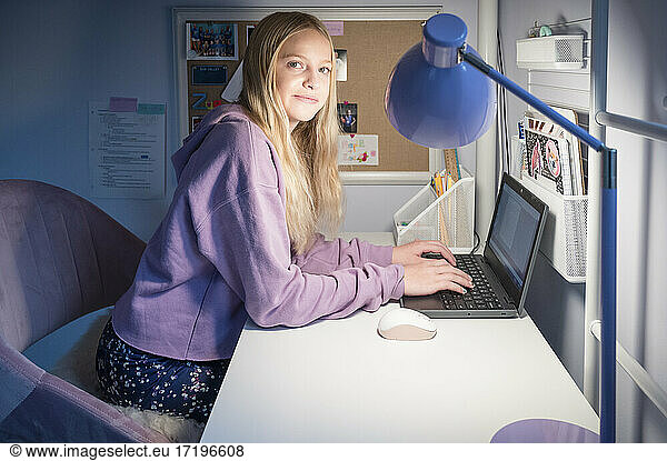 Tween/Teen Girl Attending Virtual School with Laptop at Home