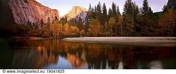 Twilight over Half Dome monolith in Yosemite National Park  California with reflection in Merced River  Fall 2010.