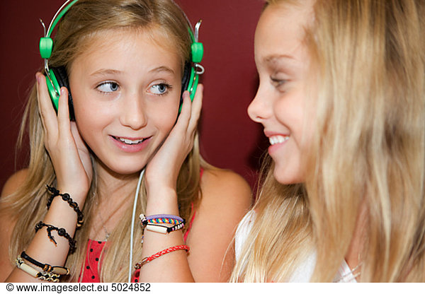 Twin girls listening to music