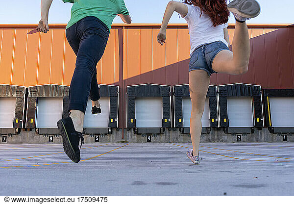 Two acrobats running during training  rear view