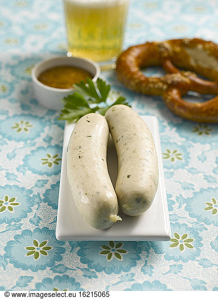 Two Bavarian veal sausages with pretzel and sweet mustard  close-up