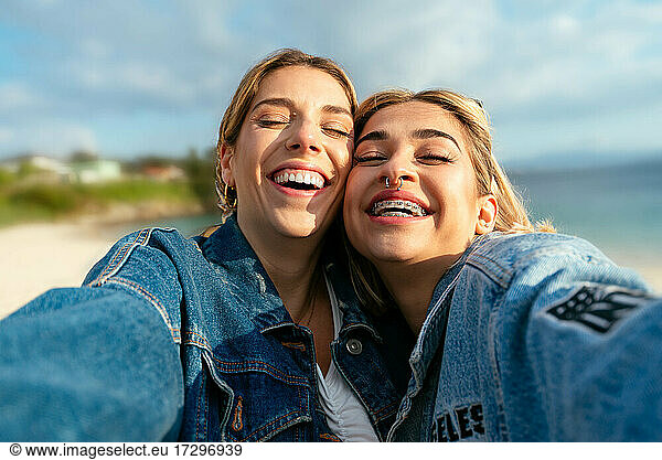 Two beautiful smiling female friends taking a selfie