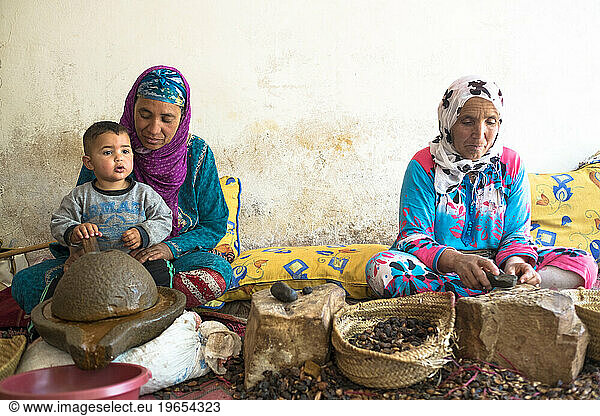 Two Berber Women In Traditional Clothing Extract Argan Oil From Kernels Of The Argan Tree