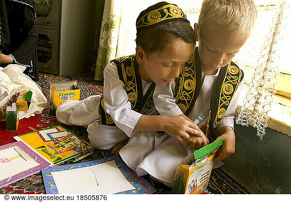 Two boys explore a box of crayons during an art class at a Kabul preschool.