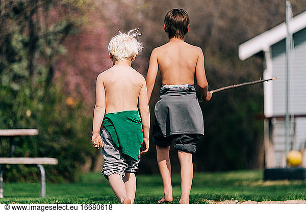Two boys walking away from camera