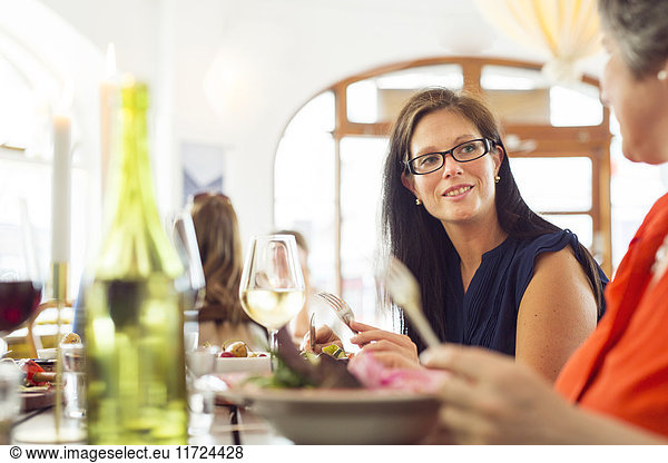 Two businesswomen talking during lunch in restaurant