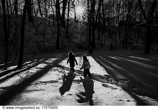 Two children in snow hiking