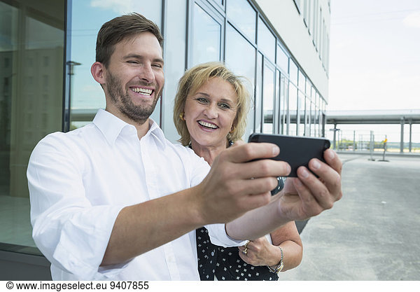 two colleagues with smartphone