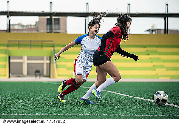 Two female soccer players on the field