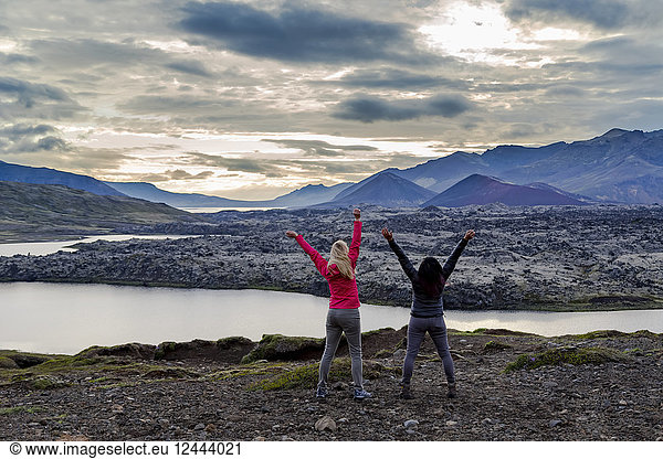Two female travellers celebrate their hike and embrace the excitement of this beautiful nature viewpoint in Western Iceland  Iceland