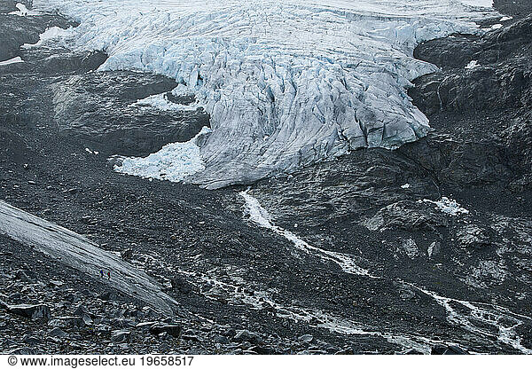 Two figures descend the tongue of the Storbreen Glacier near Norway's Jotunheimen National Park.