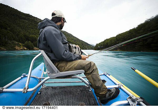 Two fisherman float down the Rio Baker in southern Chile in a region called Patagonia.