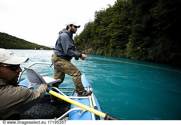 Two fisherman float down the Rio Baker in southern Chile in a region called Patagonia.