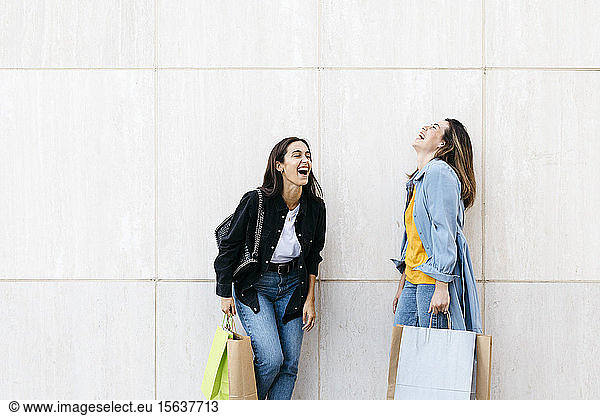 Two friends laughing during shopping