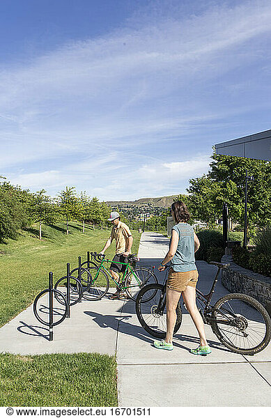 Two friends park their bikes at a rack at a park in The Dalles  Oregon