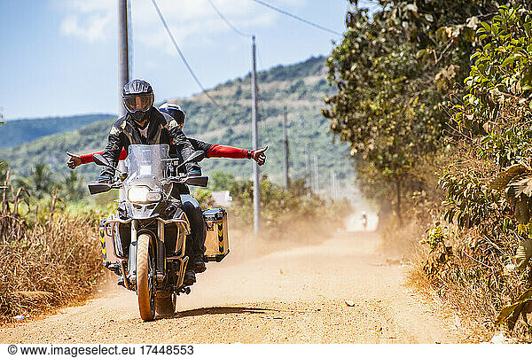 two friends riding on their adventure motorbike on dirt road