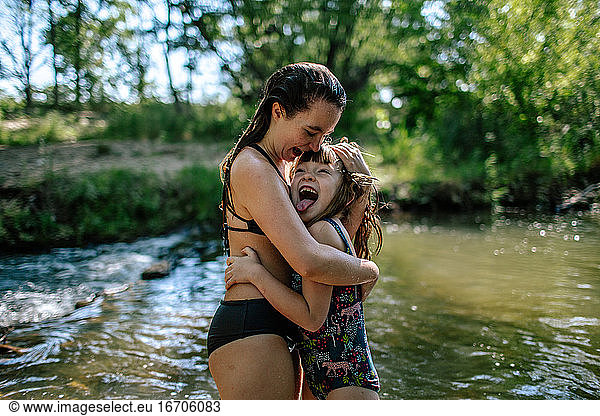 Two girls hugging and laughing on a warm summer day