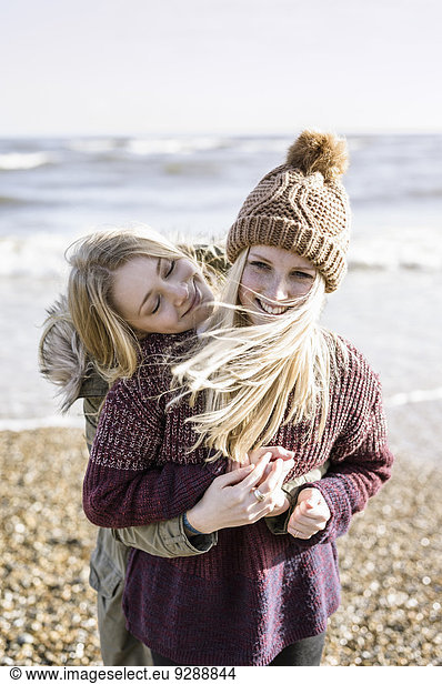 Two girls on the beach in winter.