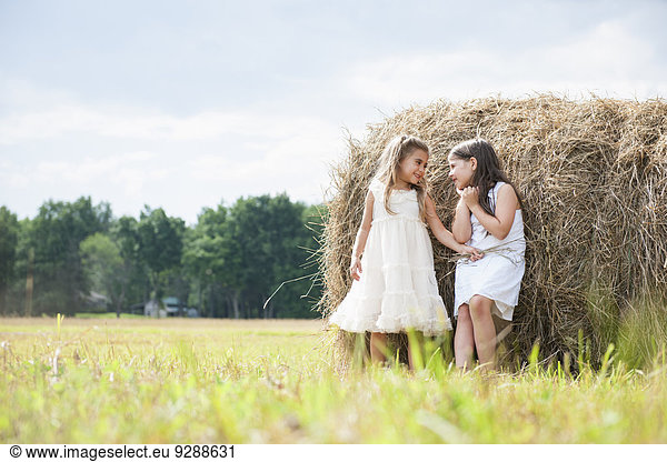 Two girls playing outdoors.