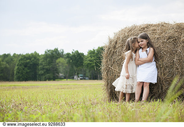 Two girls playing outdoors.