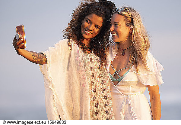 Two happy women taking selfie on the beach  Costa Rica