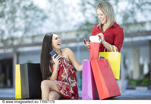 Two happy women with shopping bags