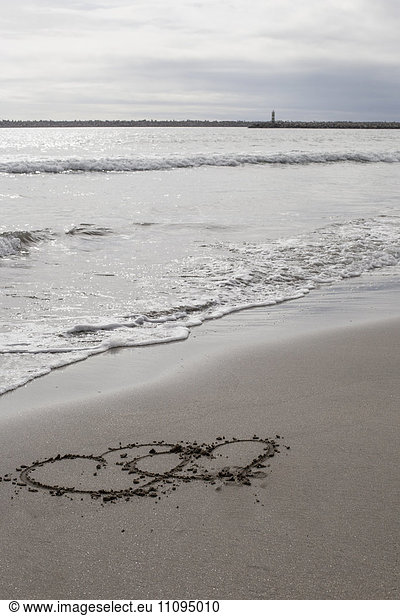 Two heart shape drawn in sand on the beach  Viana do Castelo  Norte Region  Portugal