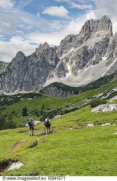 Two hikers on a marked hiking trail from the Adamekhütte to the Hofpürglhütte  mountain ridge with mountain peak Große Bischofsmütze  Salzkammergut  Upper Austria  Austria  Europe