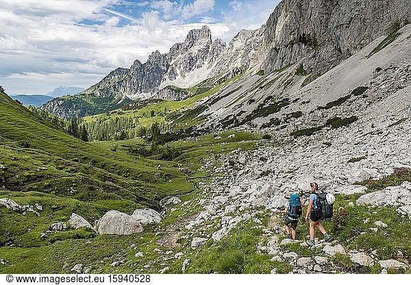 Two hikers on a marked hiking trail from the Adamekhütte to the Hofpürglhütte  view of mountain ridge with mountain peak Große Bischofsmütze  Salzkammergut  Upper Austria  Austria  Europe