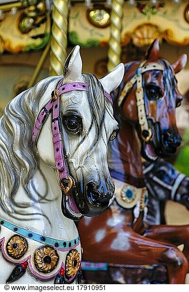 Two horse figures  horse heads  horses in a nostalgic children's carousel  close-up  France  Europe