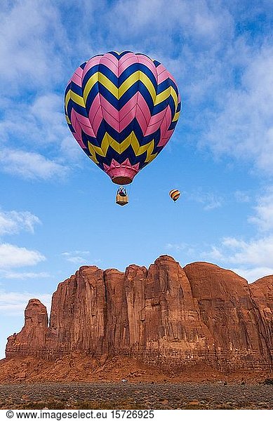Two hot air balloons fly over Camel Butte  Balloon Festival in the Monument Valley  Monument Valley Navajo Tribal Park  Arizona  USA  North America