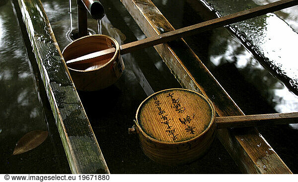 Two Japanese ladles rest in a fountain at a Shinto temple in Kawagoe  northern Tokyo  Japan.