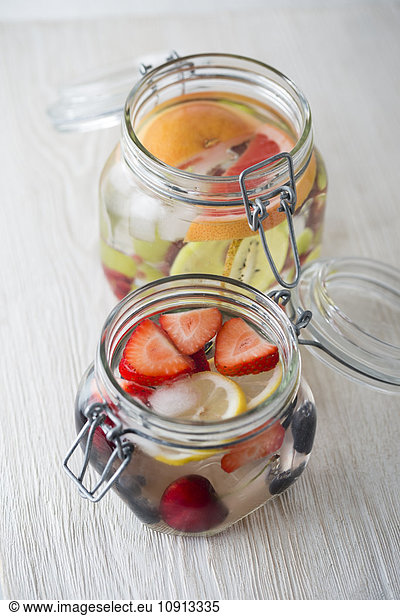 Two jars of cooled water flavoured with different fruits
