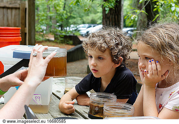 Two kids learning about animals that live in a state park