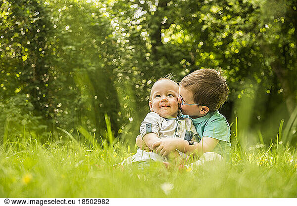 Two little brothers having fun in the garden