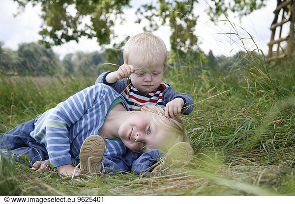 Two little brothers on a meadow