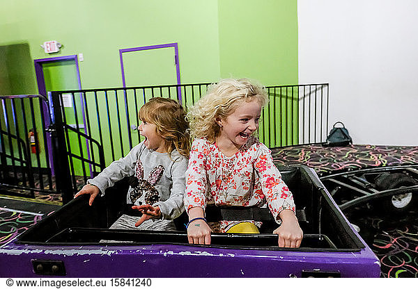 two little girls laughing with joy on rollercoaster