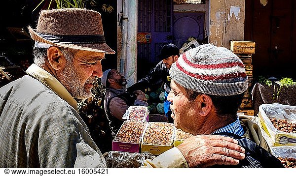 Two local men chat in the street in Taliouine  a little mountain village in the south of Morocco.