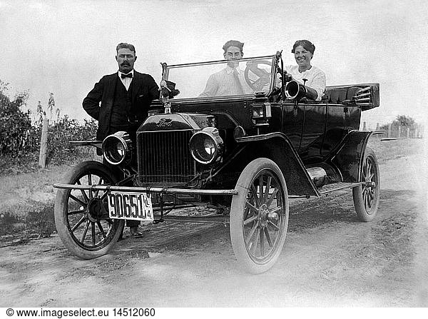 Two Men and a Woman with a Ford Model T Automobile  1914