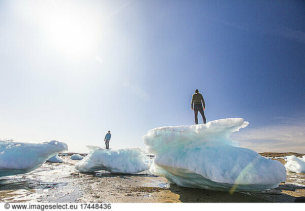 Two men standing on sea ice chunks  Iqaluit  Canada.